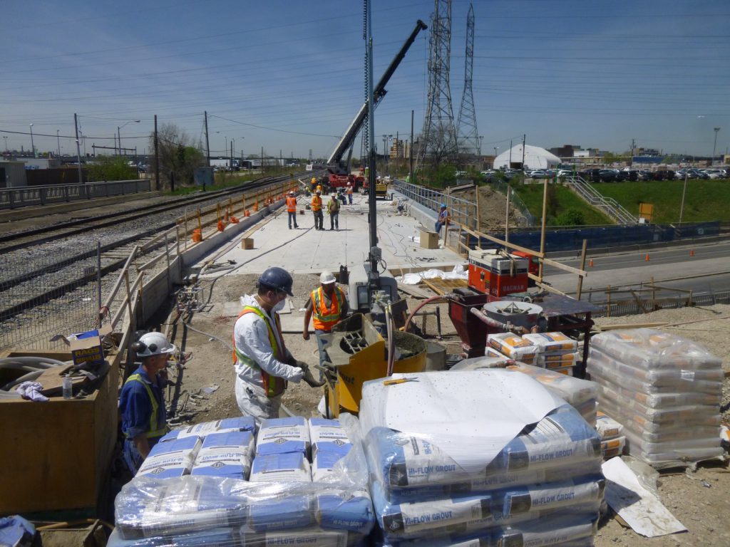 Crew mixing skids of Hi-Flow non-shrink grout on the Kipling Avenue bridge deck