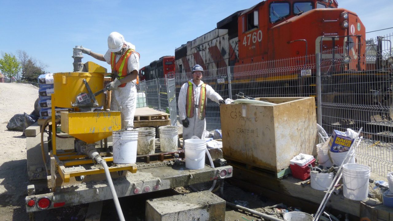 Grout mixing and pumping operations beside the rail corridor during the Kipling Avenue bridge girder grouting project