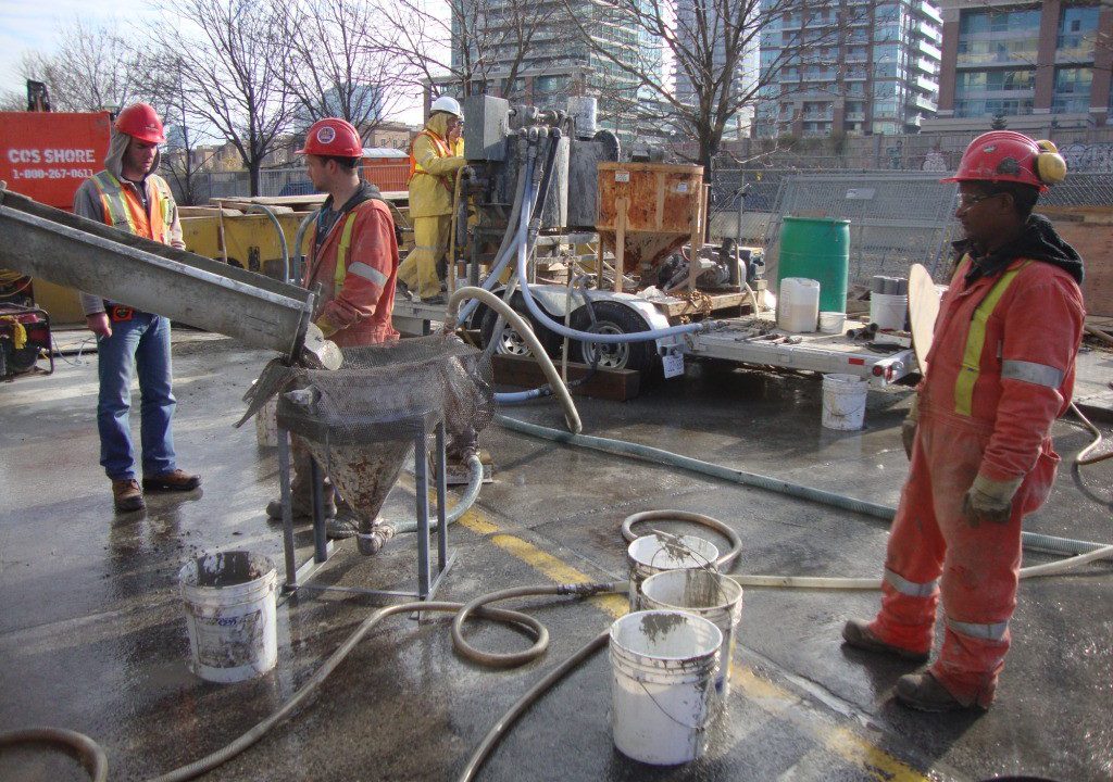 Grouting crew operating a colloidal grout mixing plant on a Toronto job site
