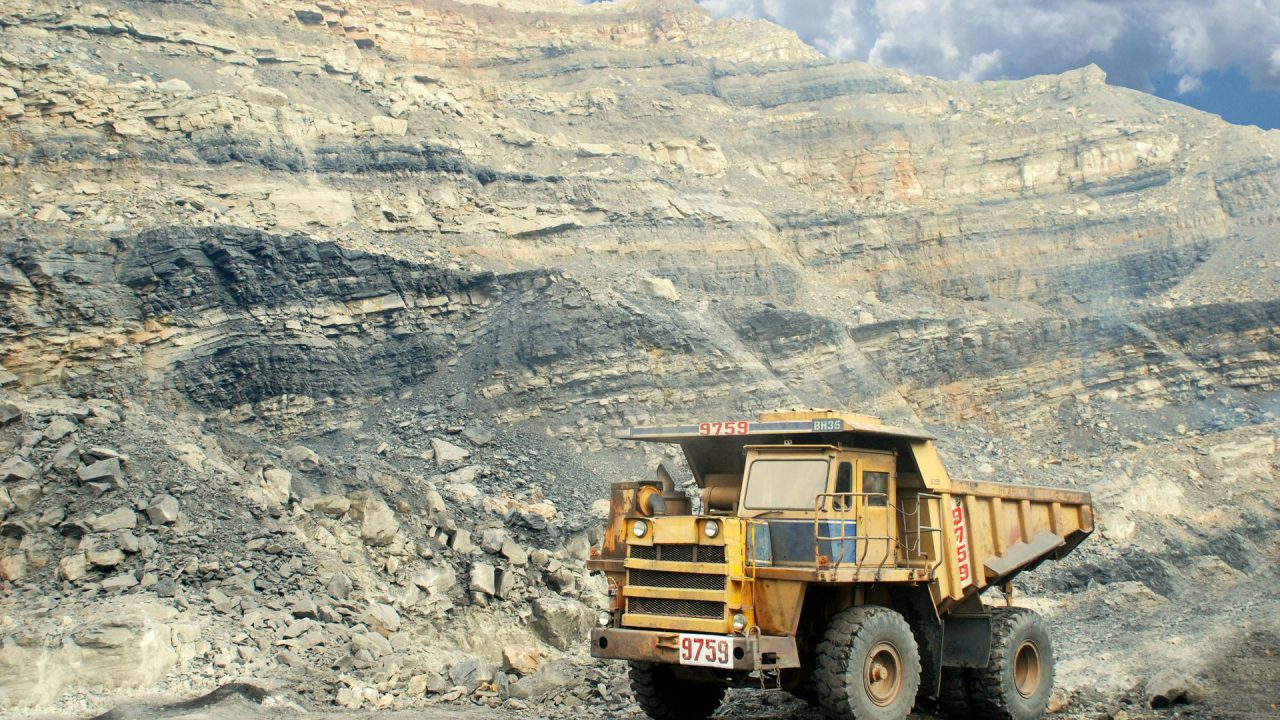 Mining haul truck on site — mine grouting services for water control and ground support in Canada