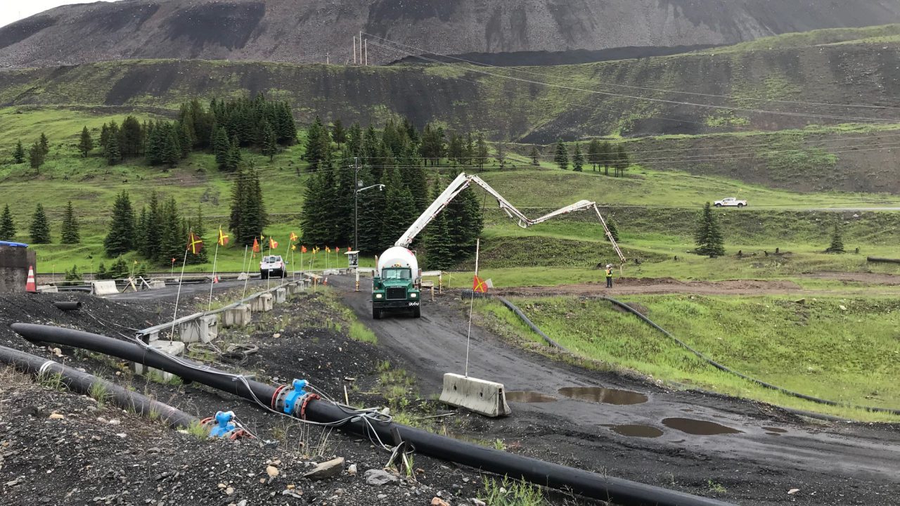 Boom pump placing flowable grout into a decommissioned pipeline on a remote right-of-way