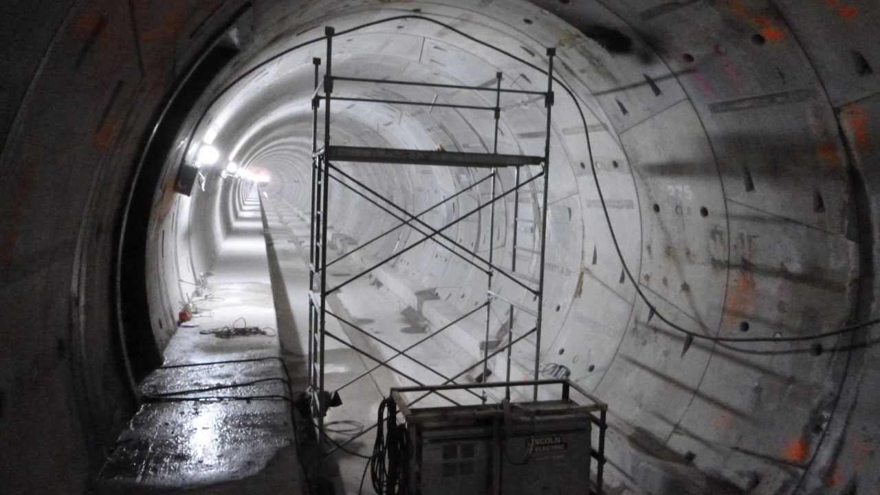 Segmental concrete tunnel liner with scaffold set up for joint grouting