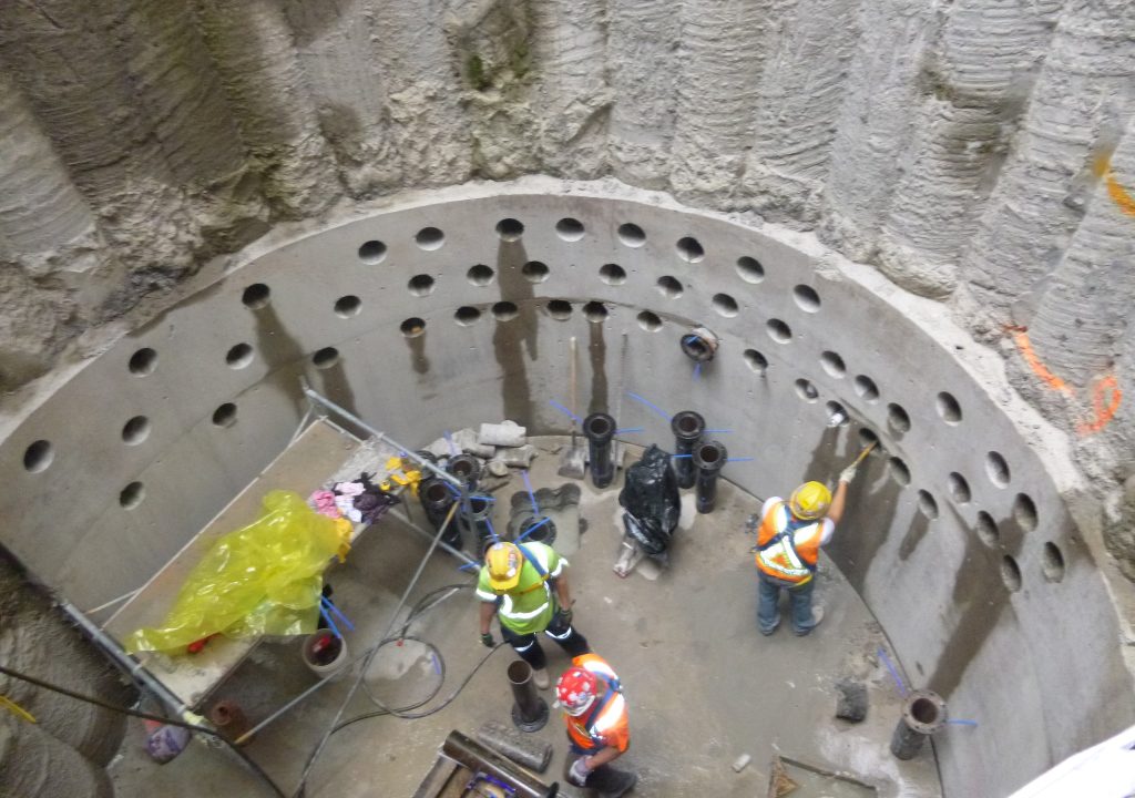 Injection drilling pattern for soil stabilization grouting at the base of a concrete shaft