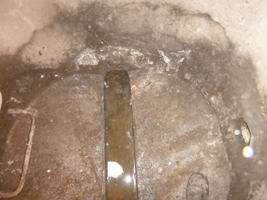 Sealed manhole pipe penetration after injection grouting with drill holes parged