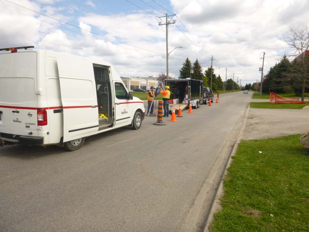 SG Services van and traffic control set up at a manhole on a residential street in Waterloo