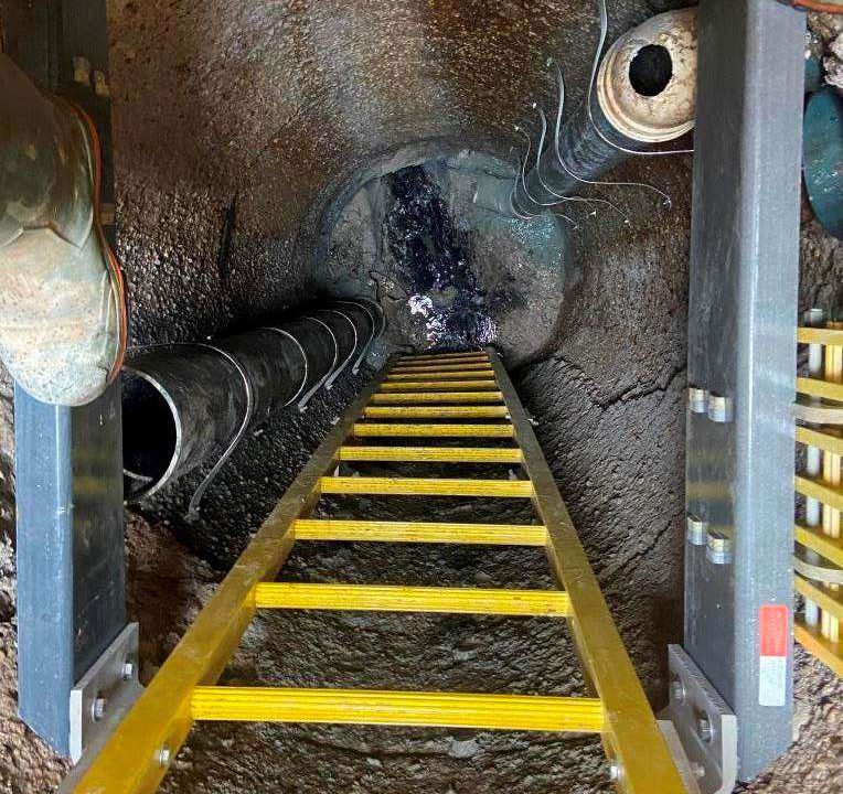 New aluminum ladder and landing installed inside a deep sanitary manhole in Wellington North