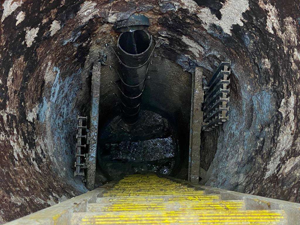 New ladder and landing anchored inside a sanitary manhole after installation